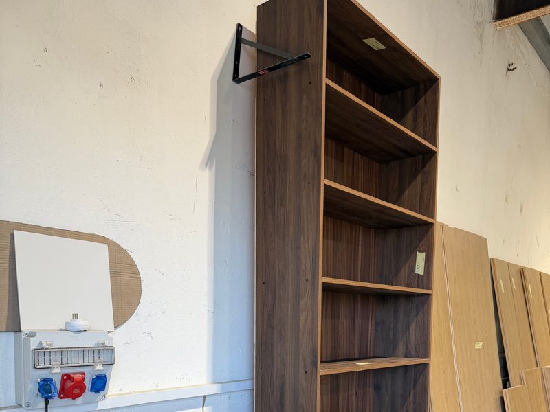 Close view of the bookcase and base cabinets against the wall