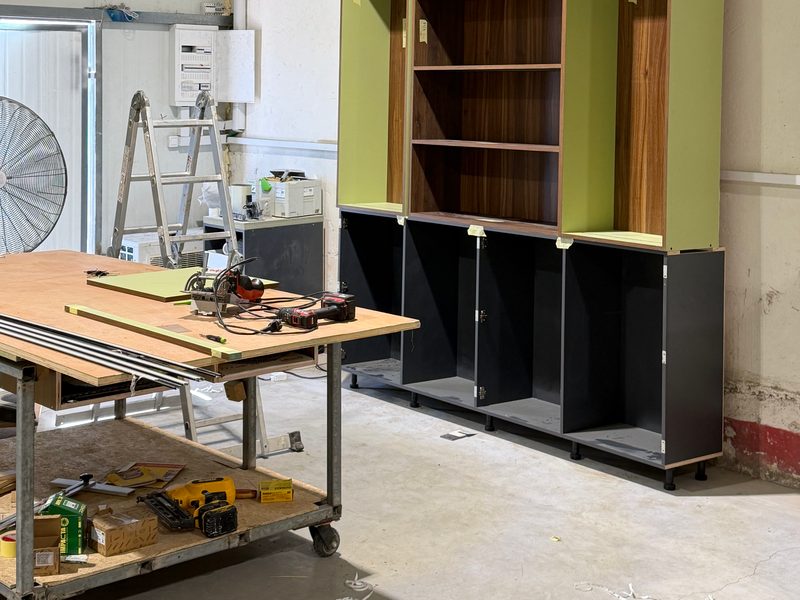 The same bookcase unit with a work cart in front