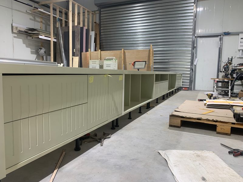 End of a long cabinet run by the workshop's roller door