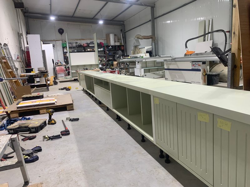 Base cabinets with labelled doors, the SCM Minimax panel saw behind
