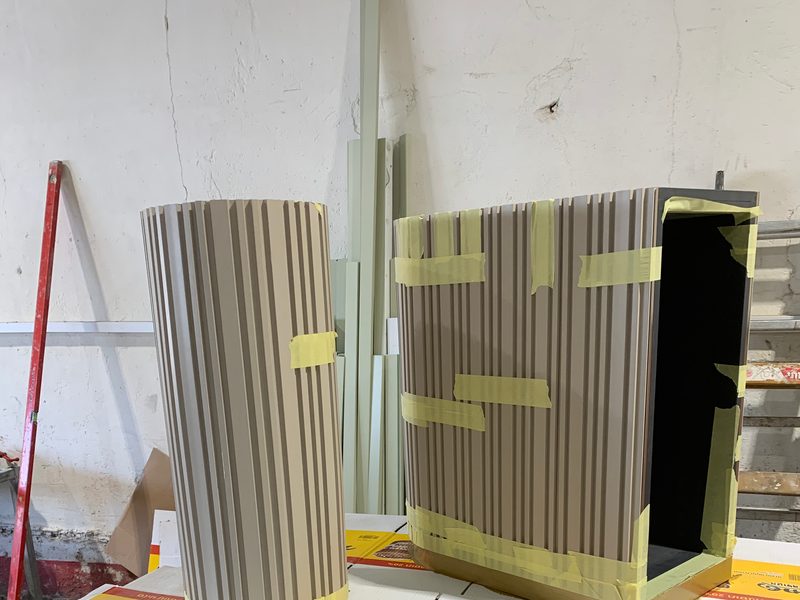 Fluted cabinet body with one side open, on trestles