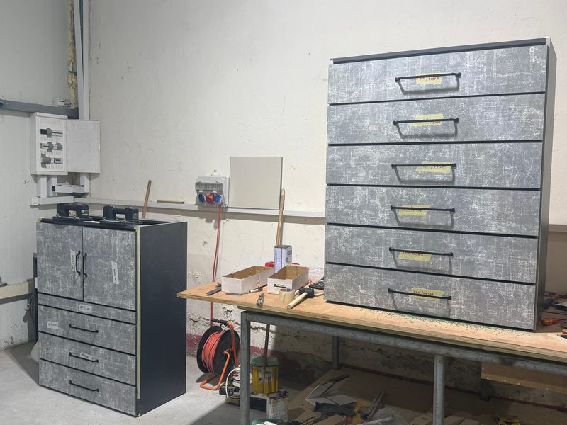 Grey stone-look chest of drawers and a smaller cabinet in the workshop