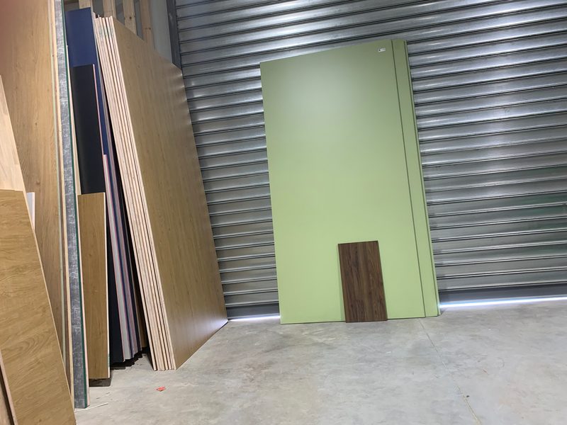 Panels and a green board leaning against the roller door
