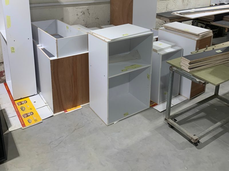 White cabinet carcasses waiting for assembly