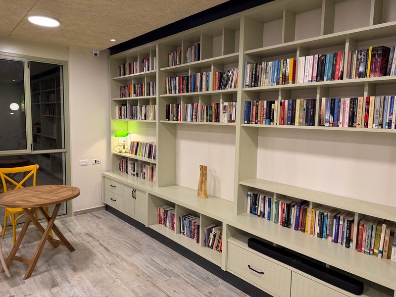 Built-in bookshelves along a wall, with cupboards and drawers