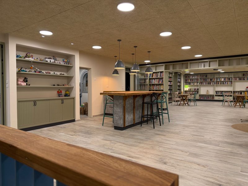 Counter with bar stools and shelving