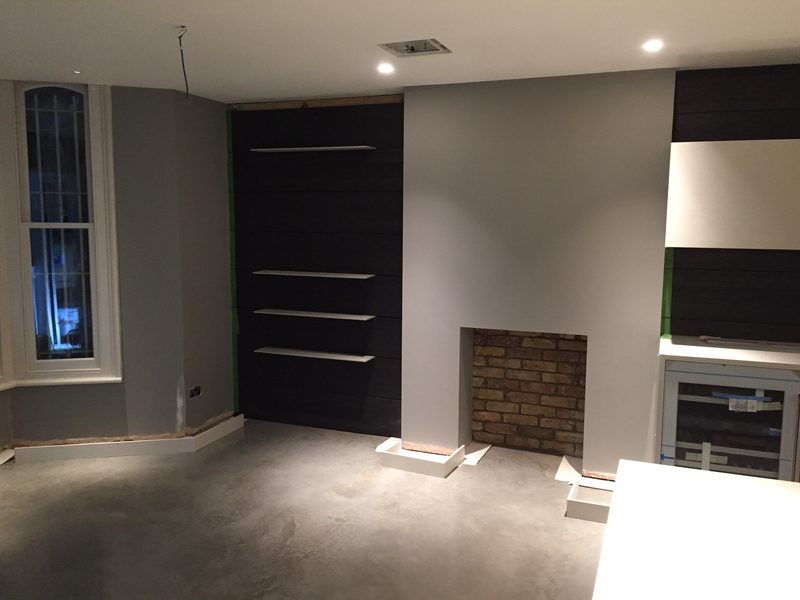 Dark panelled wall with floating shelves