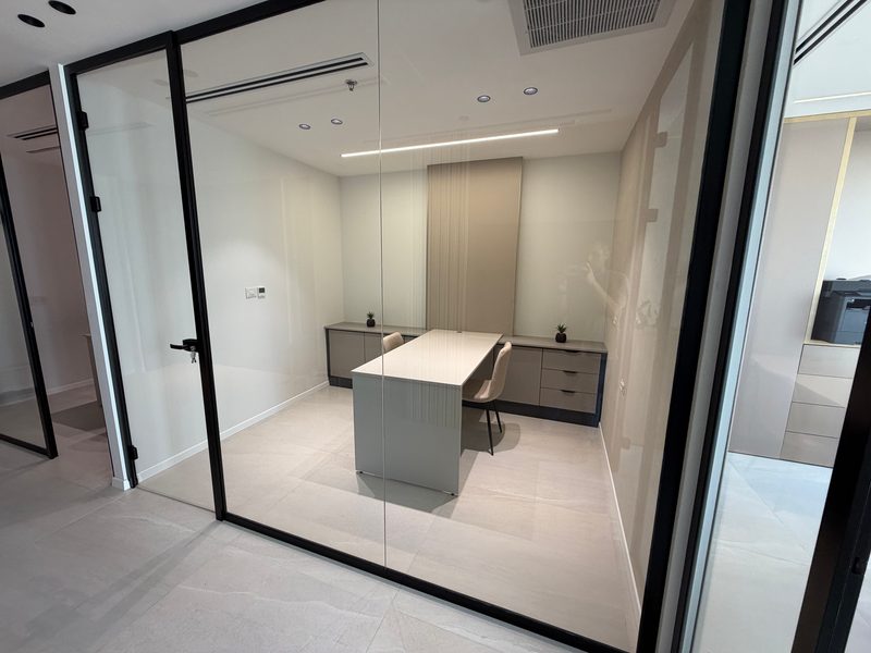 Desk and cabinets behind a glass wall