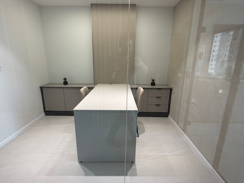 Desk and cabinets, seen through glass