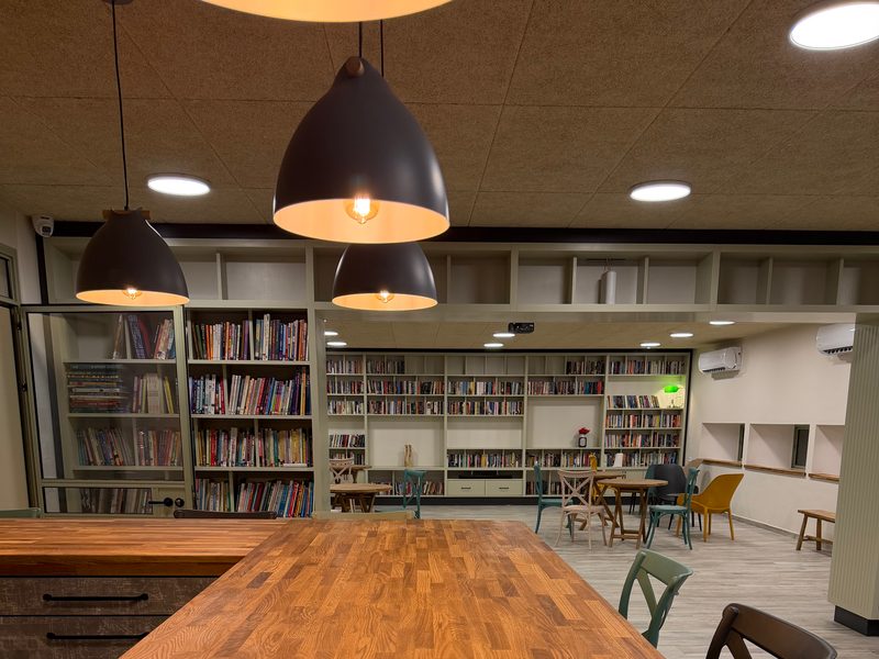 Long table with bookshelves behind