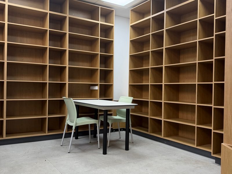 Room lined with floor-to-ceiling open shelving