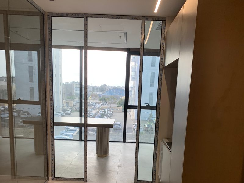 Tall cabinet and table behind glass partitions
