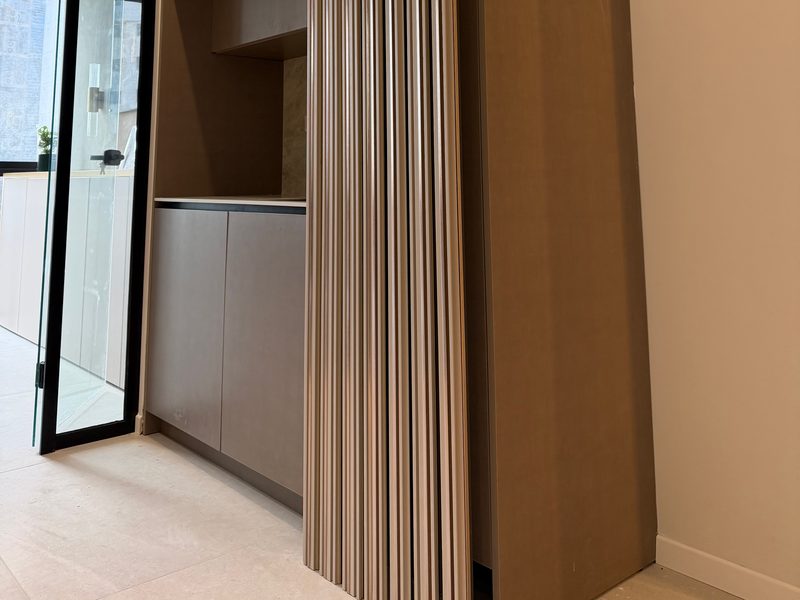 Tall cabinet with a fluted panel