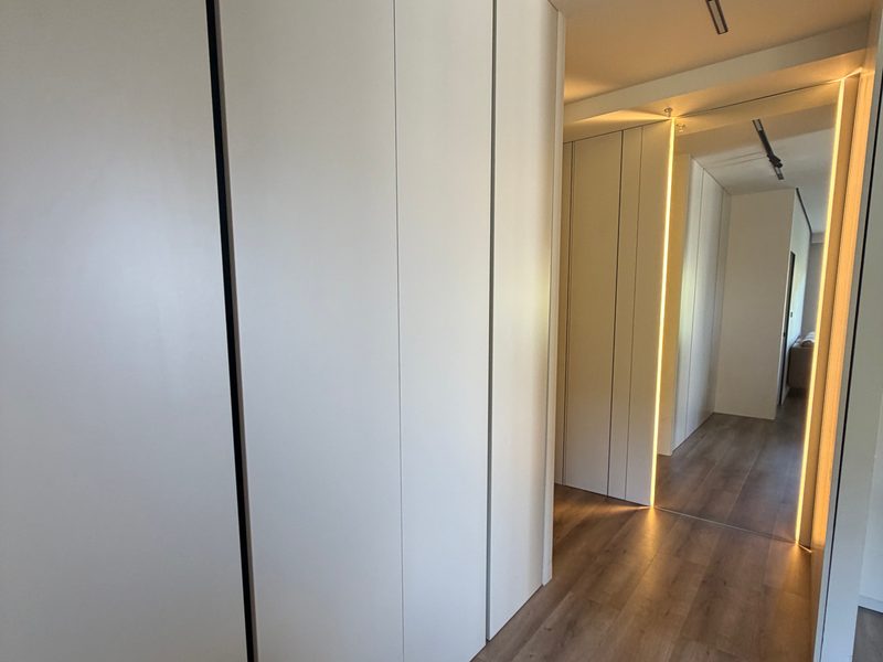 Tall white cabinets along a corridor